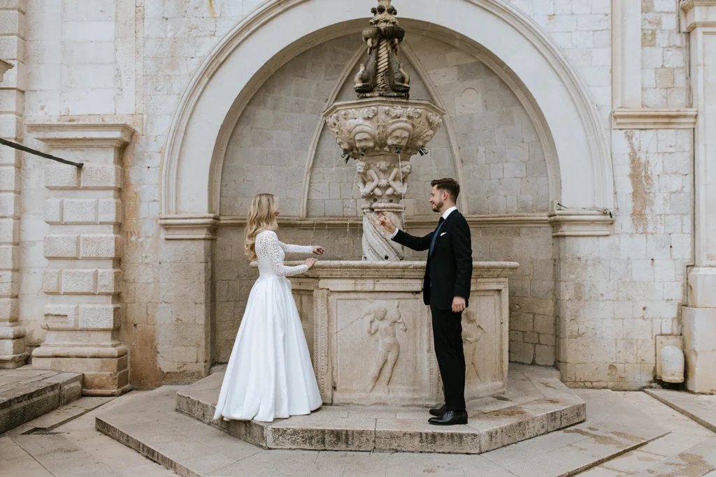 just married couple in dubrovnik at old fontain