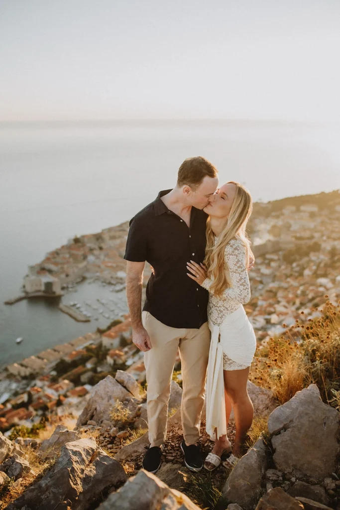 newly engaged couple kissing
