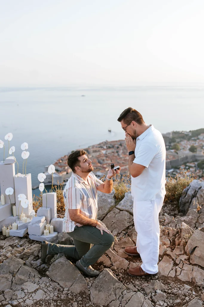 guy kneeling down proposing his partner