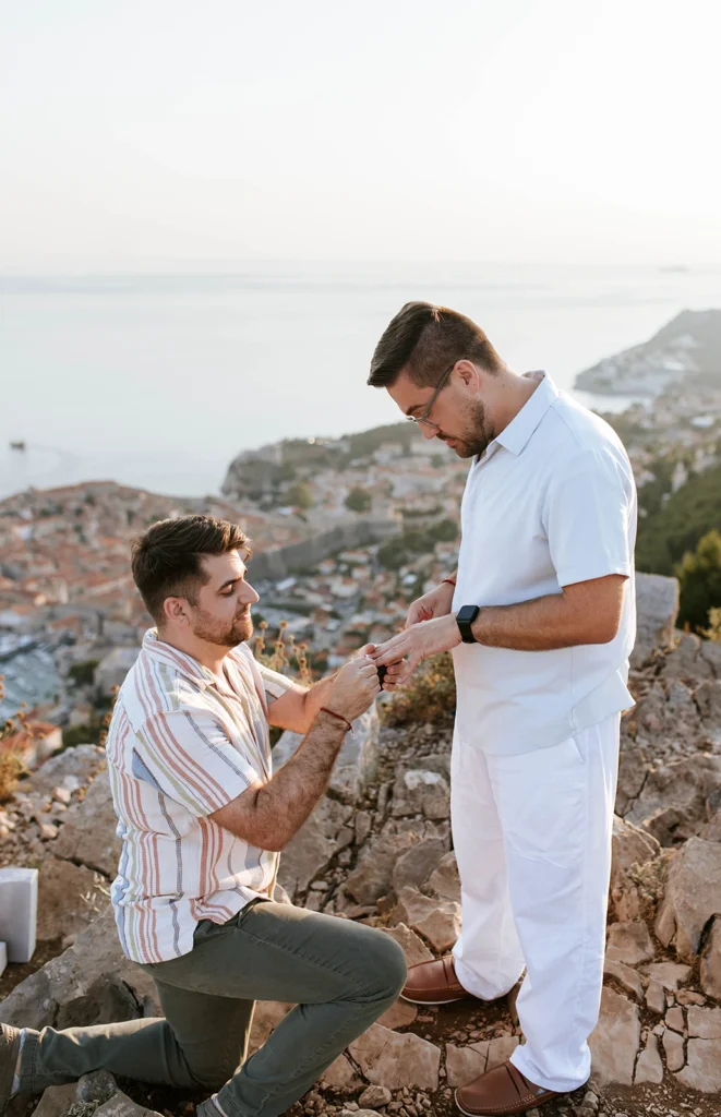guy putting finger to his partners hand