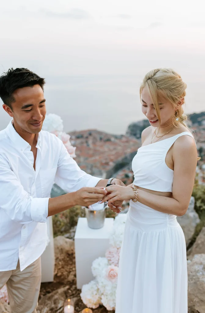 guy putting a ring on his girlfriends hand