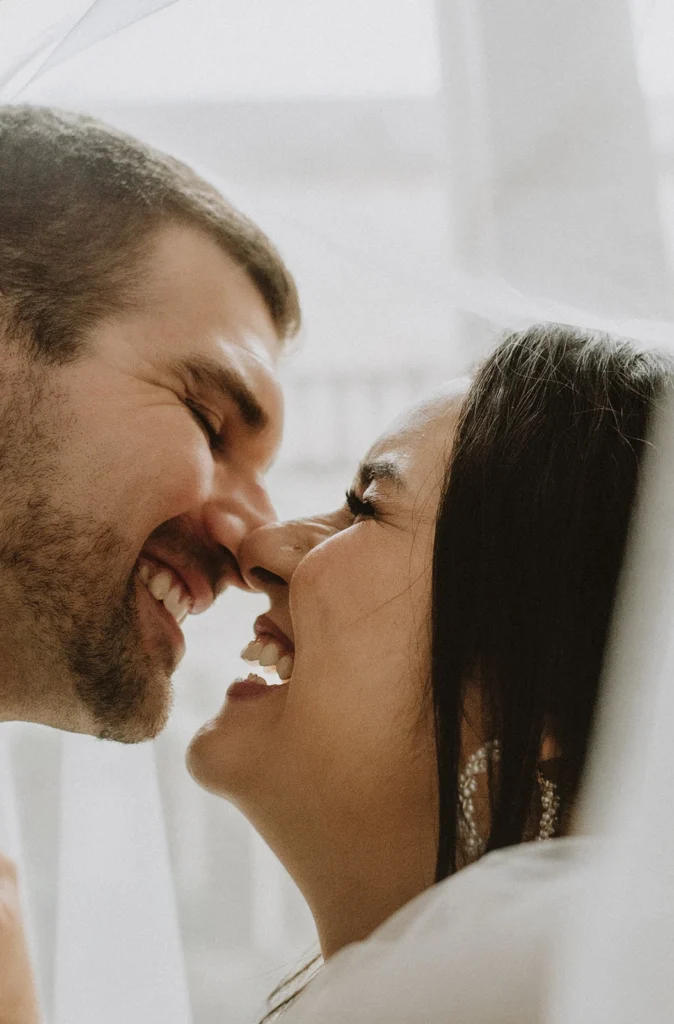 husband and wife laughing and kissing