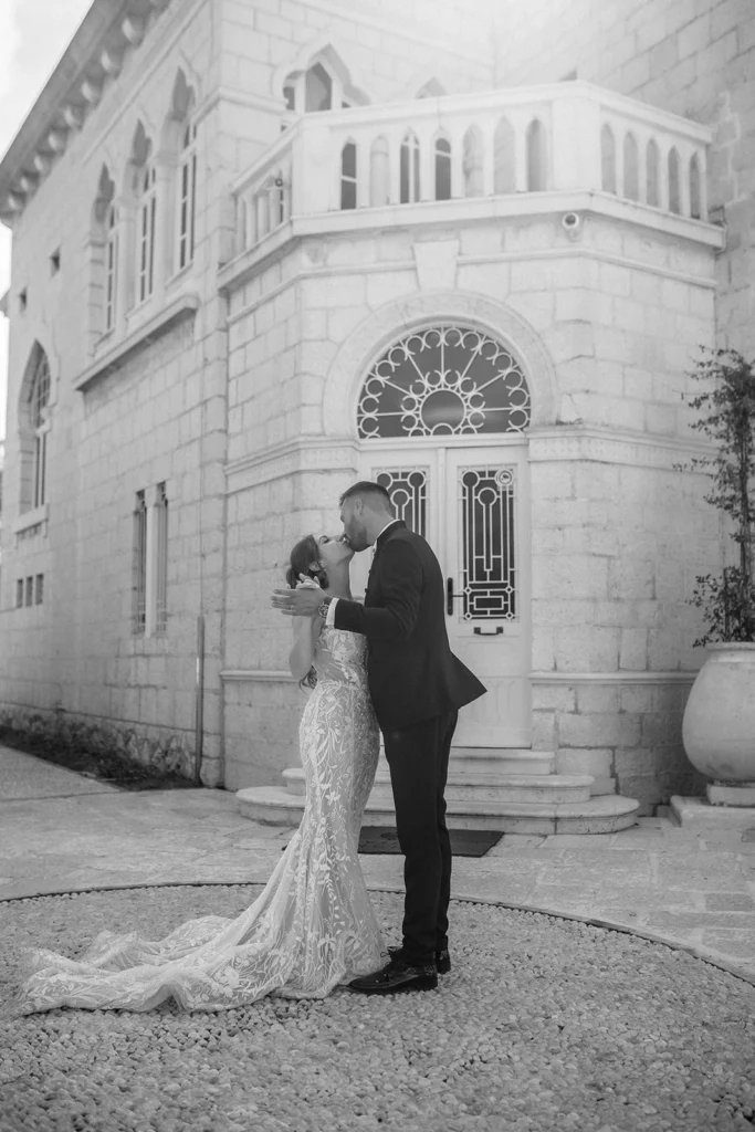 black and white photo of bride and groom kissing each other in dubrovnik croatia